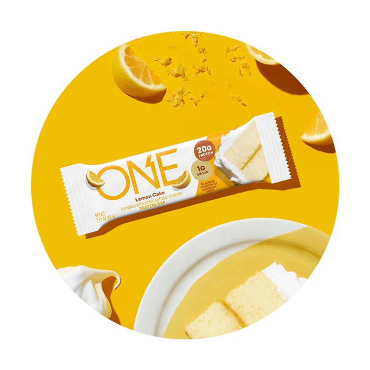 one bars lemon cake flavored protein bar surrounded by flavor cues