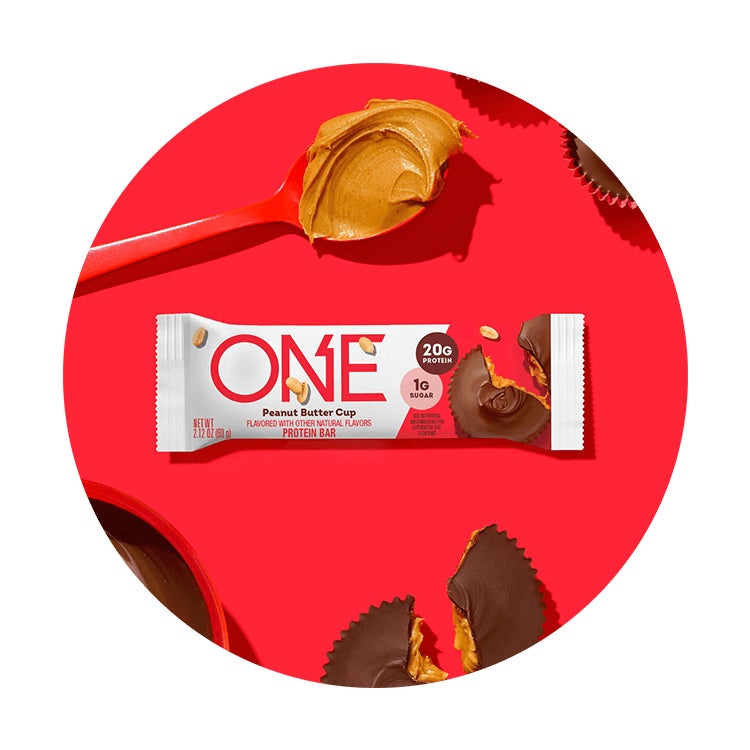 one bars peanut butter cup flavored protein bar surrounded by flavor cues