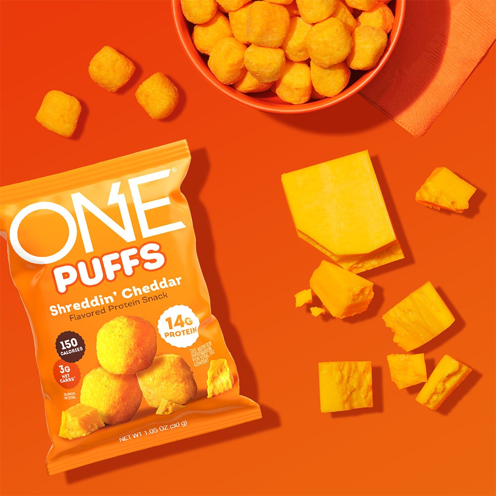 ONE PUFFS Shreddin’ Cheddar Flavored Protein Snack, 1.05 oz bag, 10 count box - Lifestyle